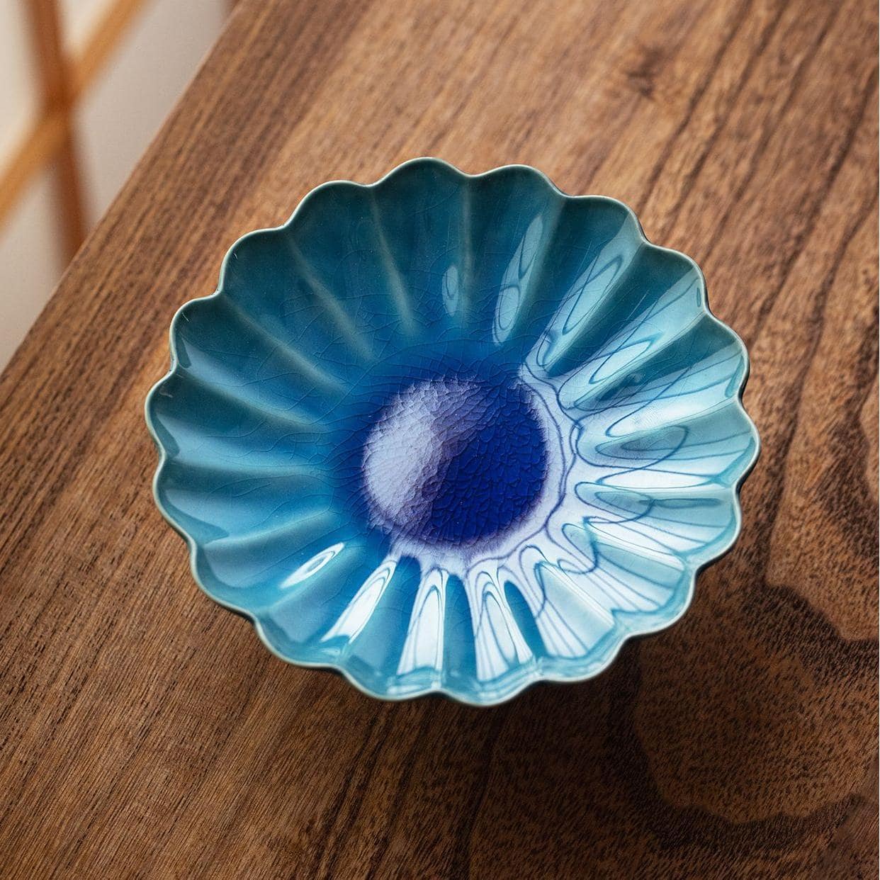 Japanese Mino glazed chrysanthemum-shaped dessert plate with vibrant blue glaze.