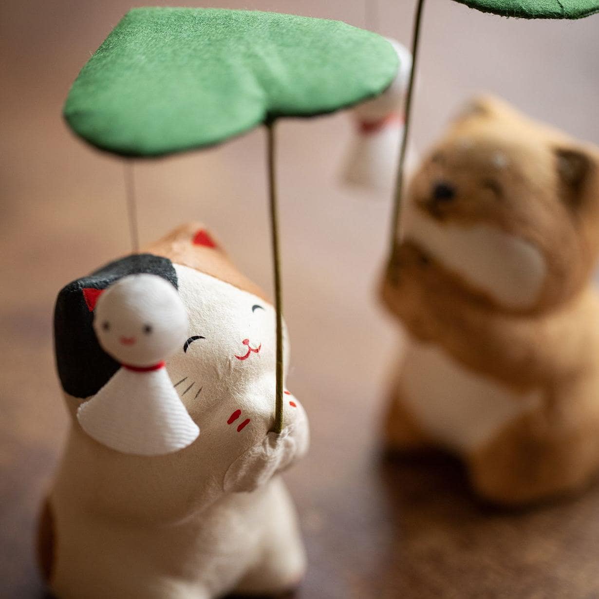 Longhutang dog figurine with clover umbrella and ladybug accent.