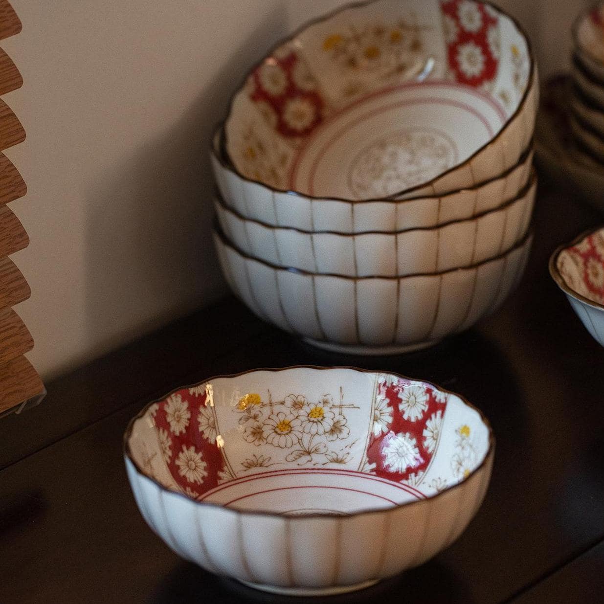 Scalloped edge ceramic plate with Japanese floral details