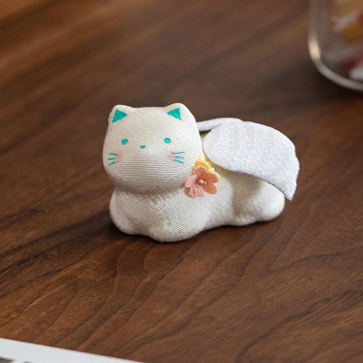 Light-colored lucky cat with angel wings on display