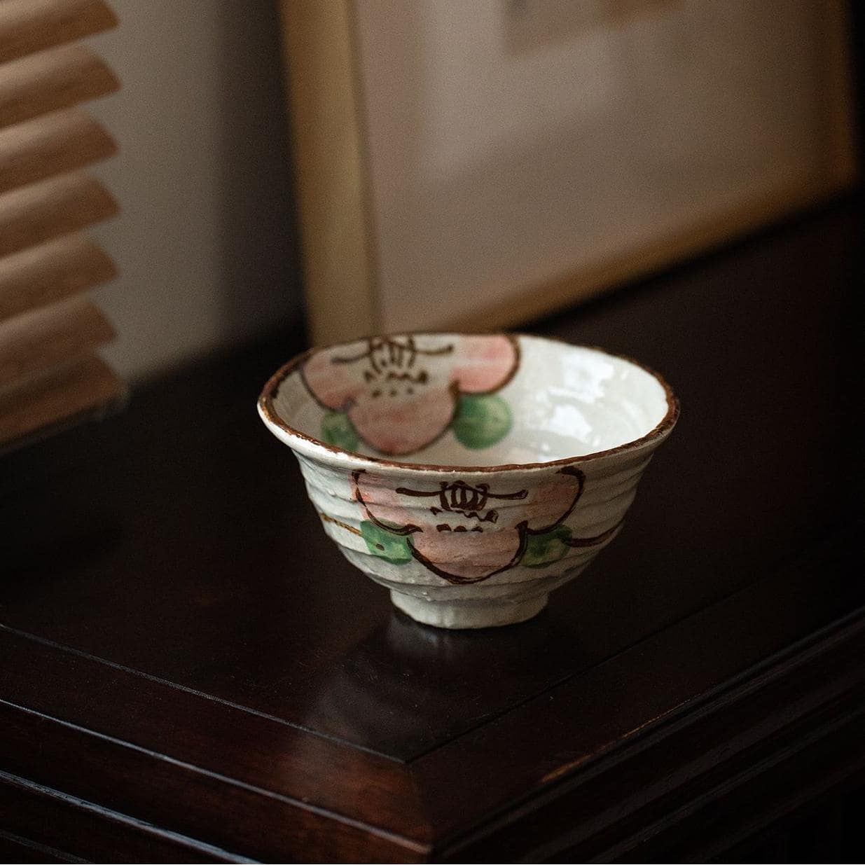 Close-up of floral details on artisanal ceramic tableware set.