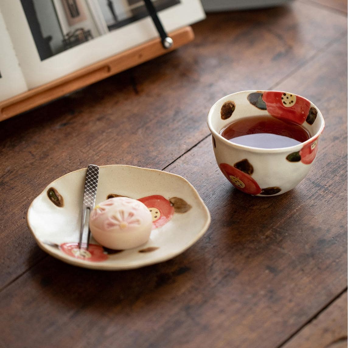 Floral ceramic cup with matching saucer on display