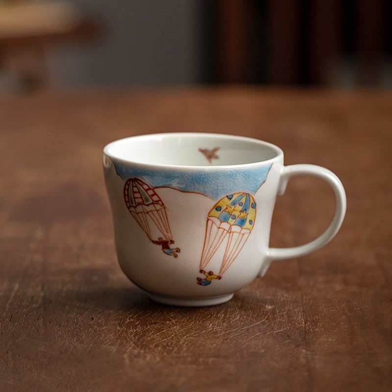 Mug with red floral patterns and tea displayed on a wooden table