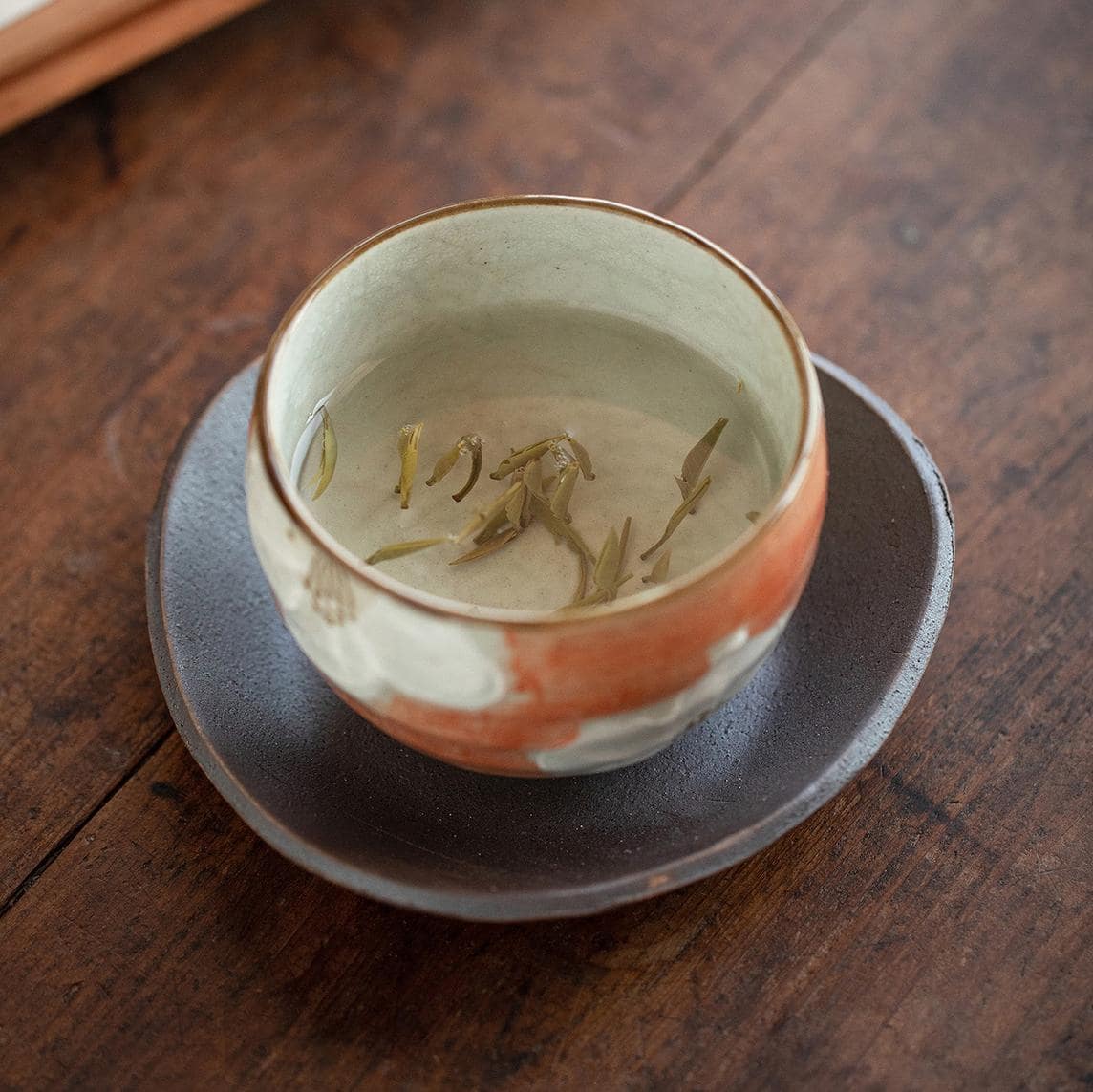 Handcrafted Japanese ceramic cup and saucer with floral patterns