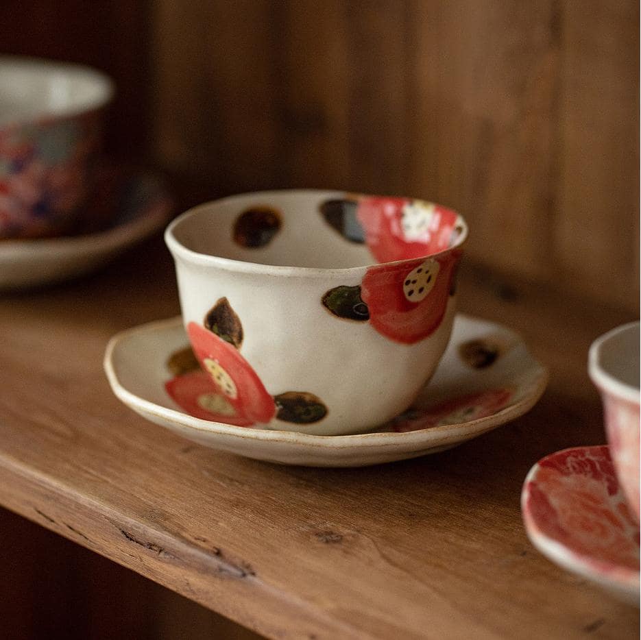 Floral ceramic cup with matching saucer on display