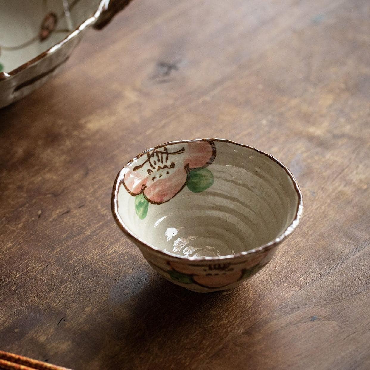 Artisan ceramic bowl set featuring traditional Japanese floral patterns.