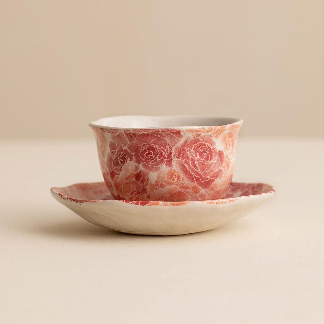 Handcrafted Japanese ceramic cup and saucer with floral patterns