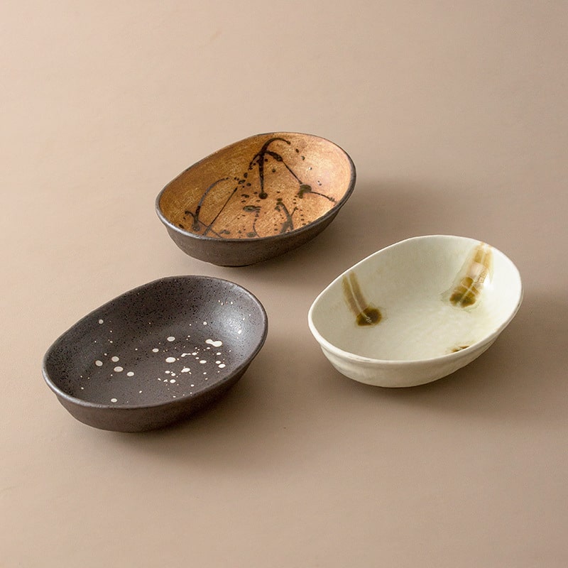 Handcrafted oval ceramic plates in rustic earthy tones