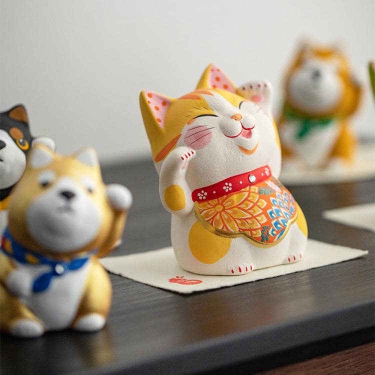 Trio of Japanese Shiba Inu figurines in vibrant colors