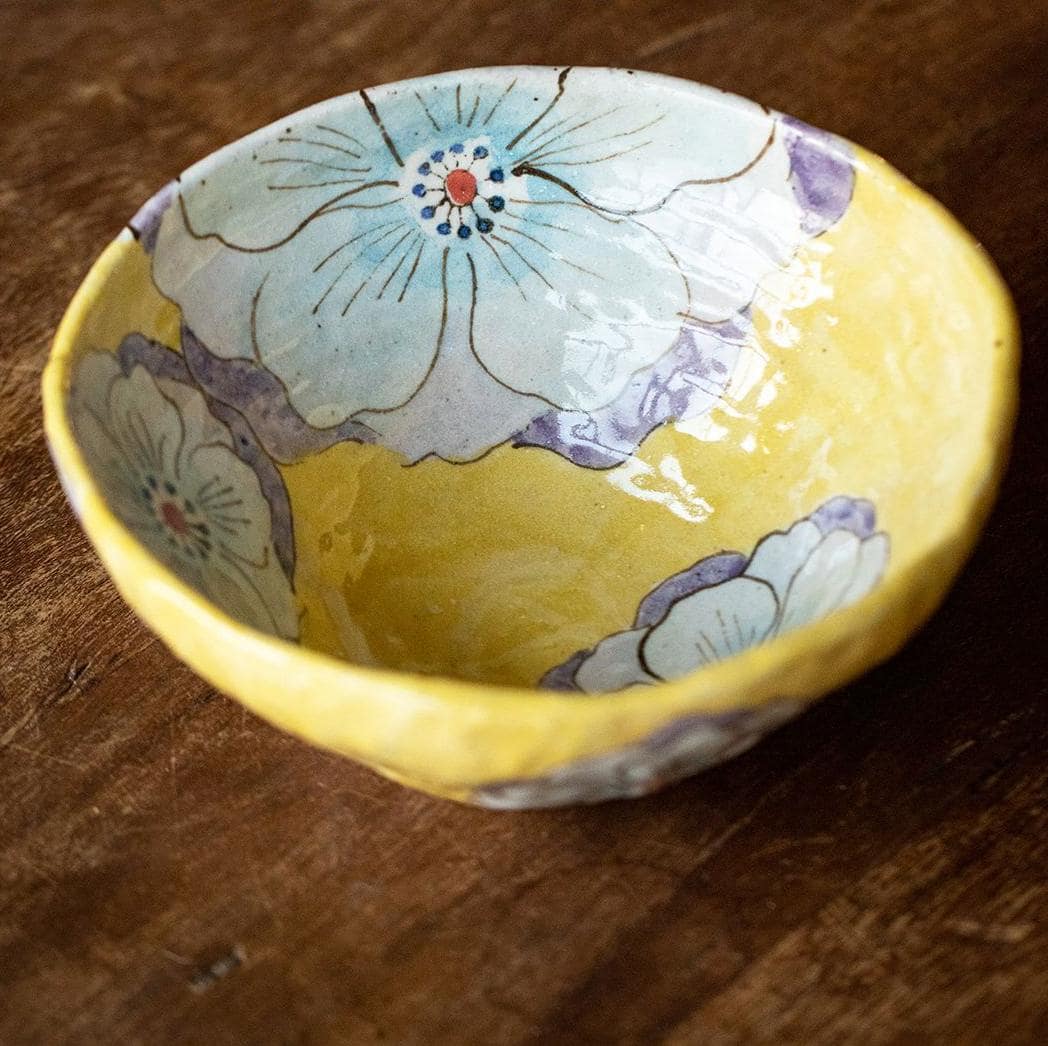 Hand-formed Japanese bowl placed on a rustic wooden surface, highlighting its artisanal craftsmanship