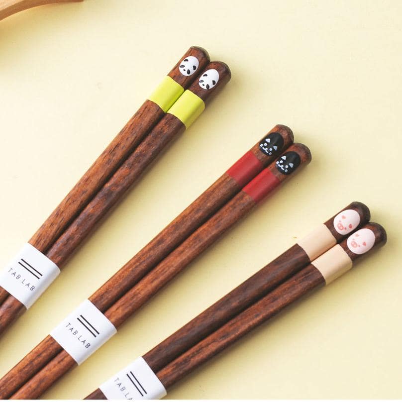 Colorful animal-themed wooden chopsticks arranged in a set