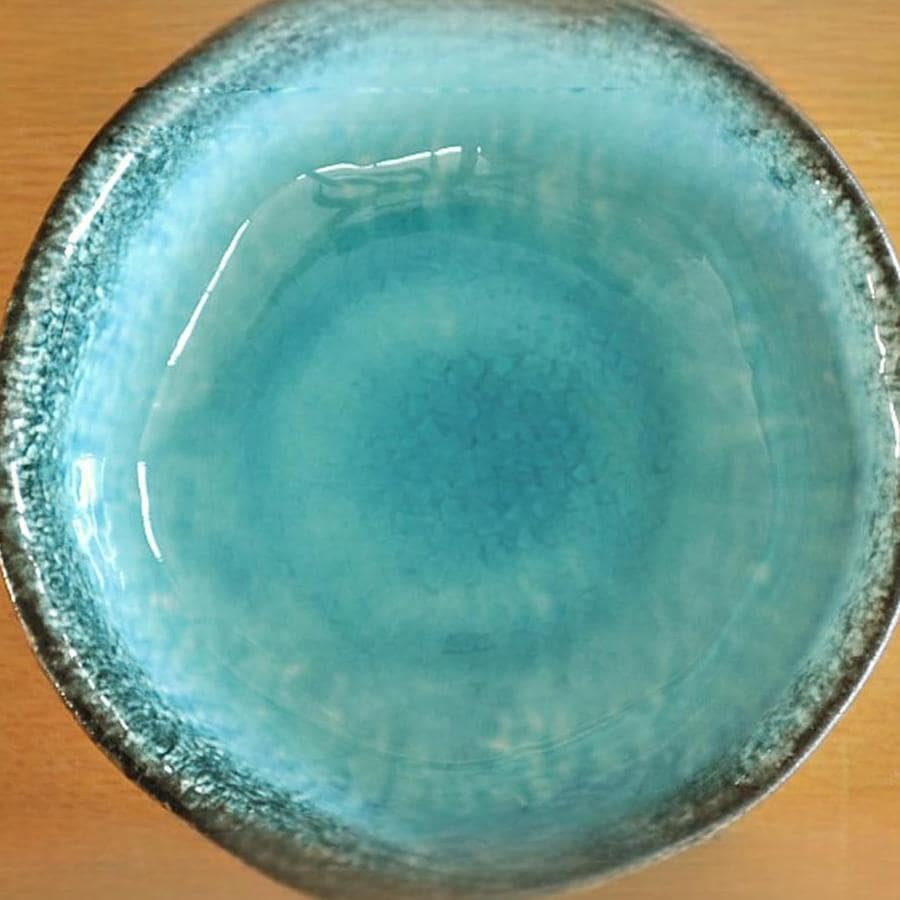 Japanese ceramic bowl serving fresh salad on a rustic table.