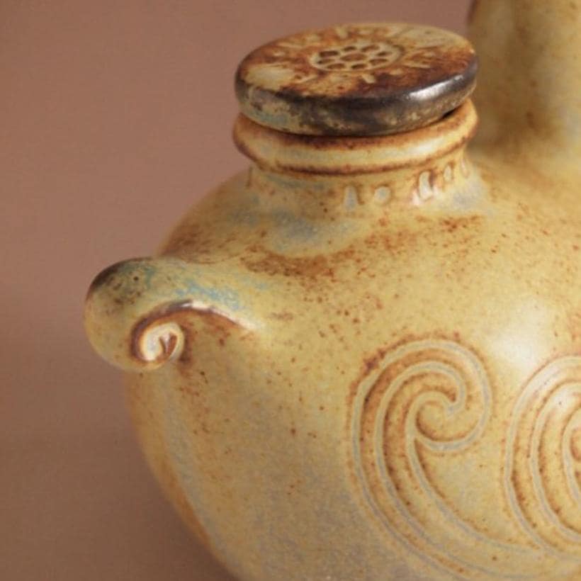 Handmade Japanese bird-shaped ceramic oil pot with swirl patterns.