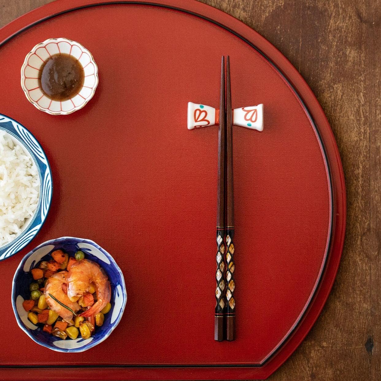 Close-up of Japanese Ishida solid wood chopsticks with intricate designs.