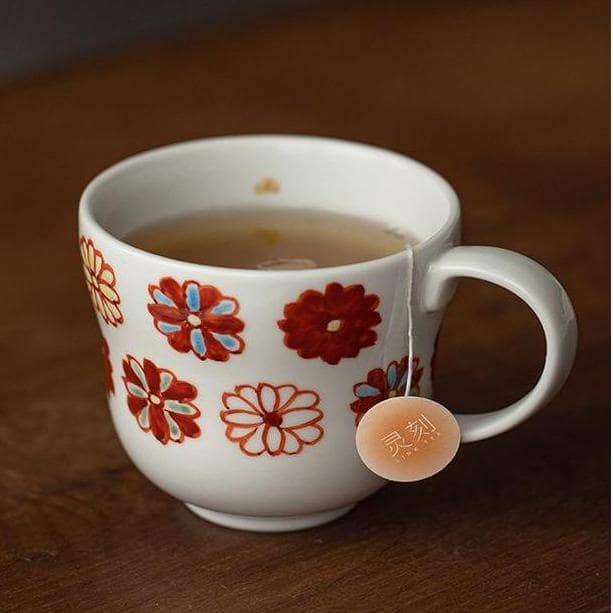 Hot air balloon-themed ceramic mug close-up on a table