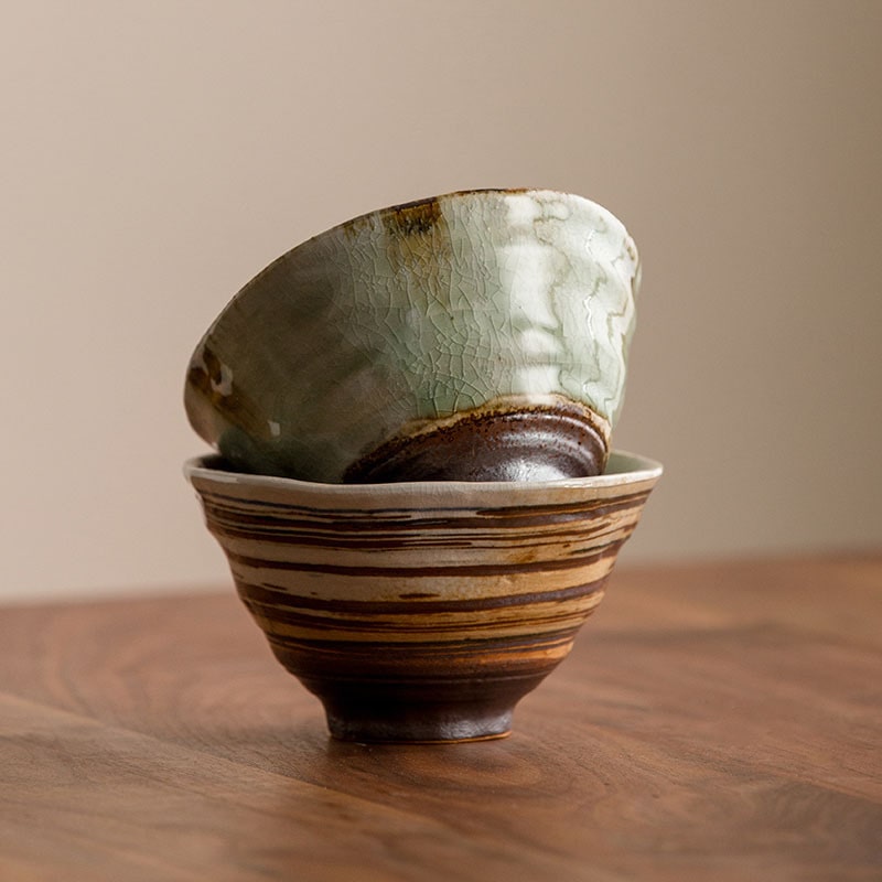 Handmade ceramic bowls with green glaze and earthy tones