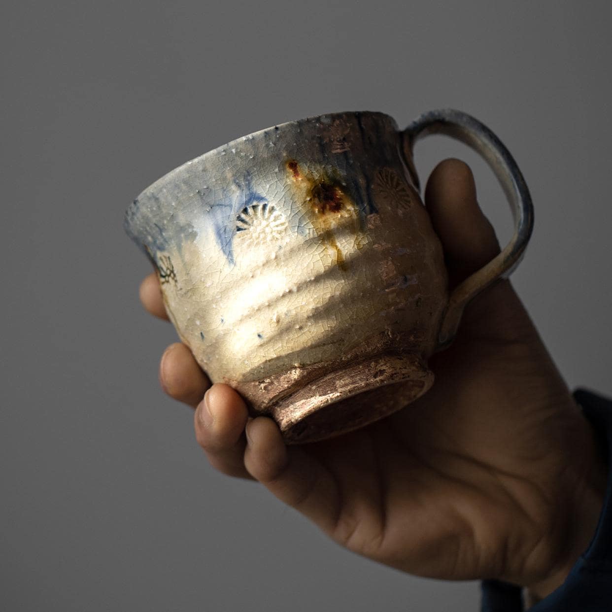 Handcrafted ceramic cups with rustic finishes