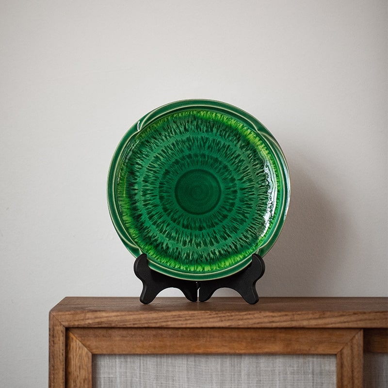 Close-up of green ceramic plate with intricate crackle design.