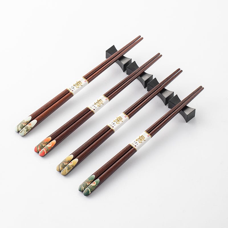 Set of dragon-themed wooden chopsticks on a white background