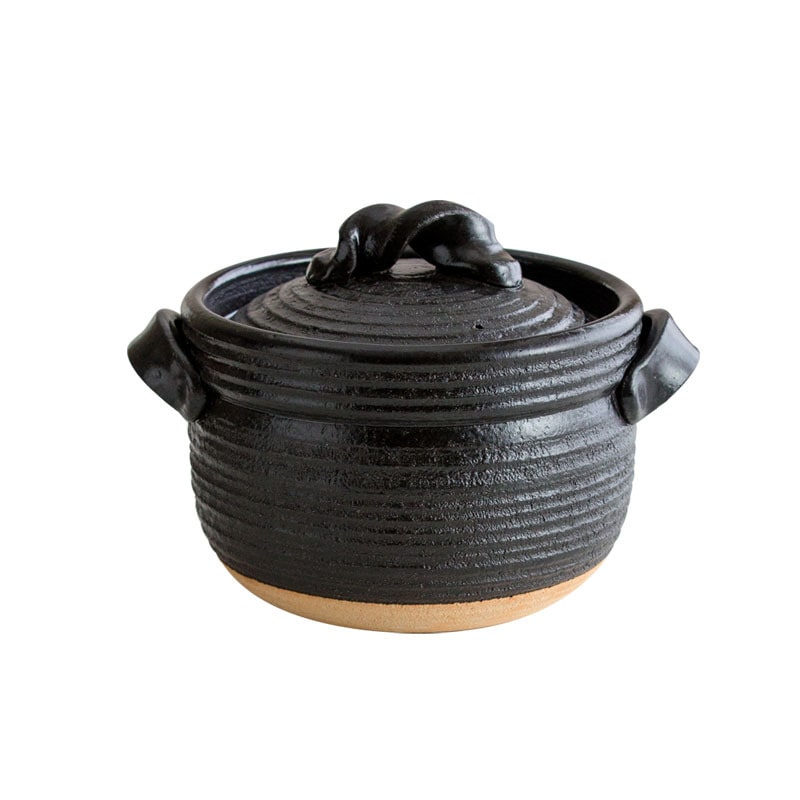 Brown Shinraku-yaki ceramic pot filled with hearty stew on a wooden table