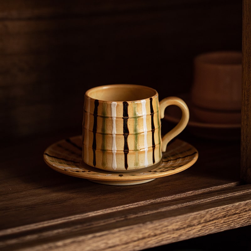 Artisan ceramic mug with textured stripes, perfect for coffee or tea.