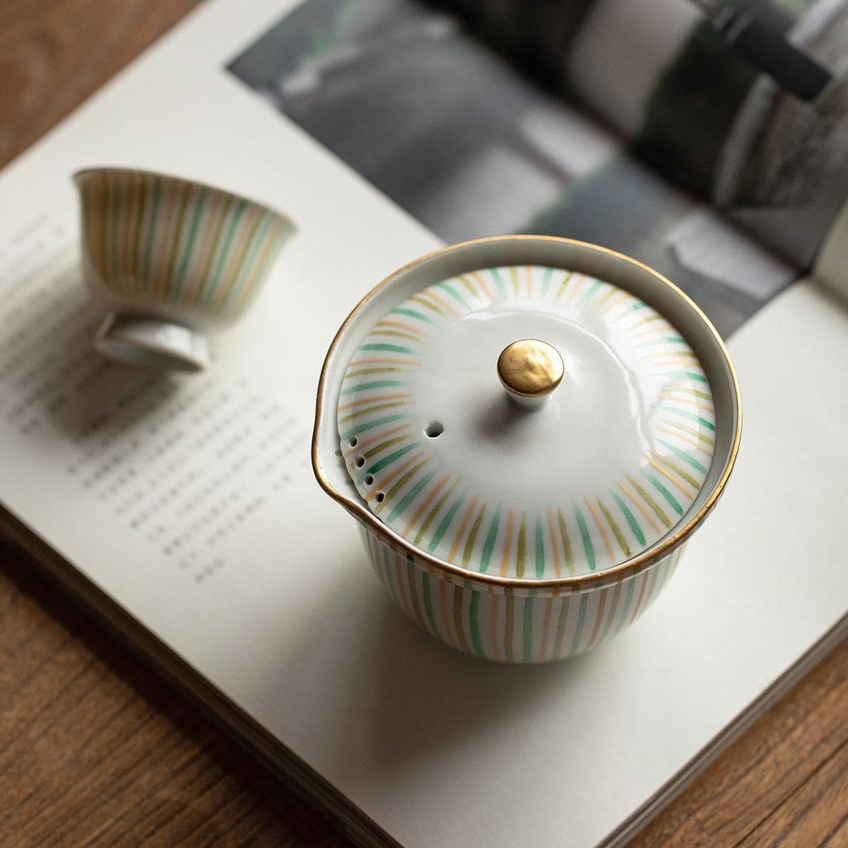 Close-up of floral-patterned Kiyomizu-yaki teacup in white and yellow.