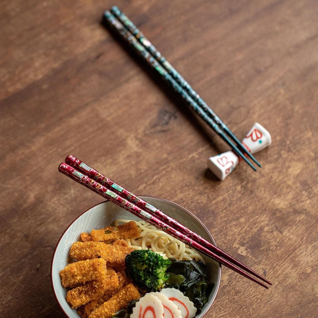 Close-up of ergonomic Japanese wooden chopsticks showcasing intricate patterns.