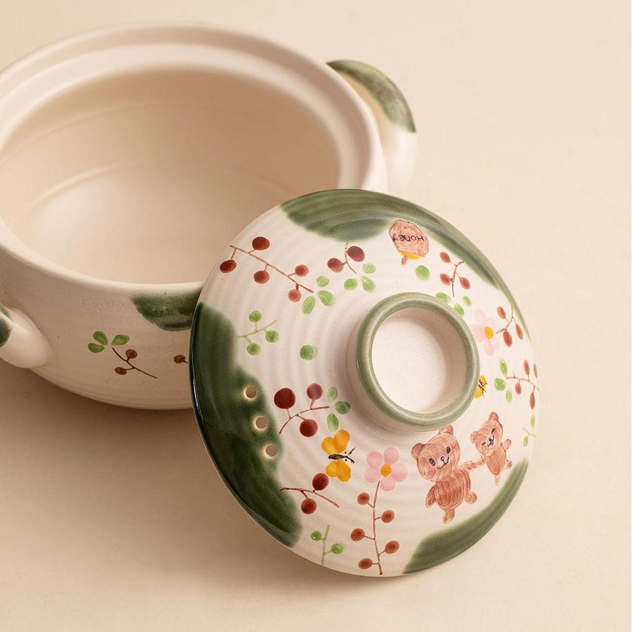 Hand-painted ceramic casserole dishes with floral and whimsical designs