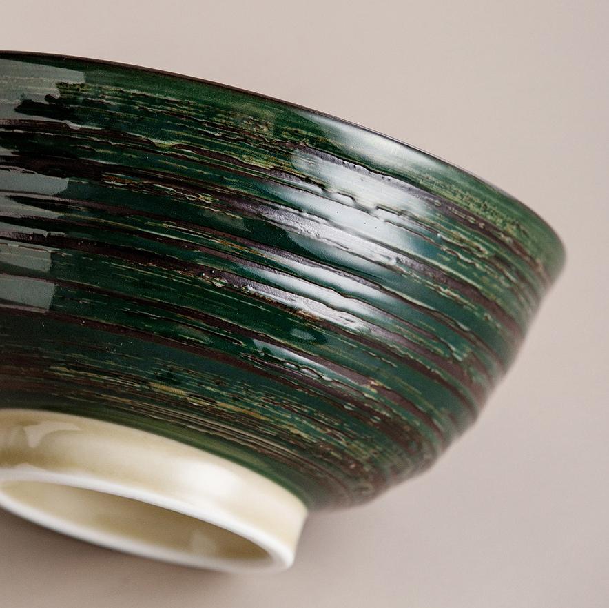 Collection of handcrafted ceramic bowls in various patterns and colors