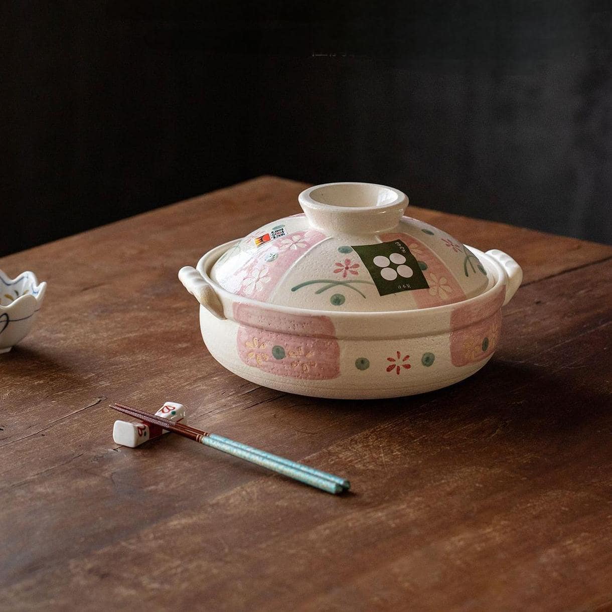 Handcrafted ceramic casserole pot with pink floral accents