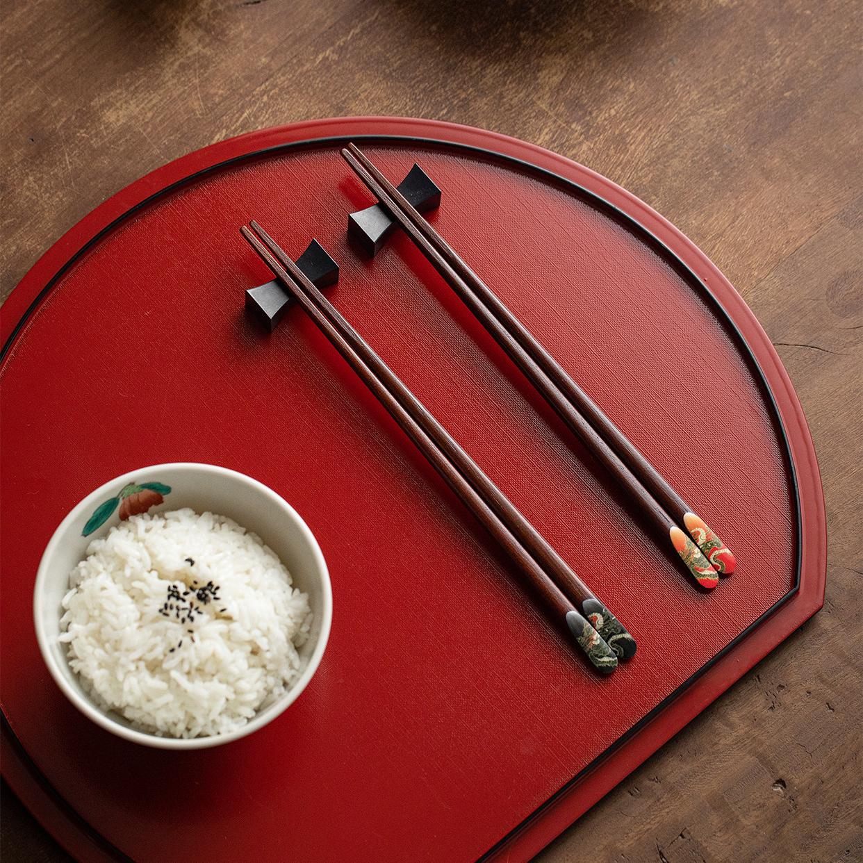 Pair of wooden chopsticks placed elegantly on a table setting