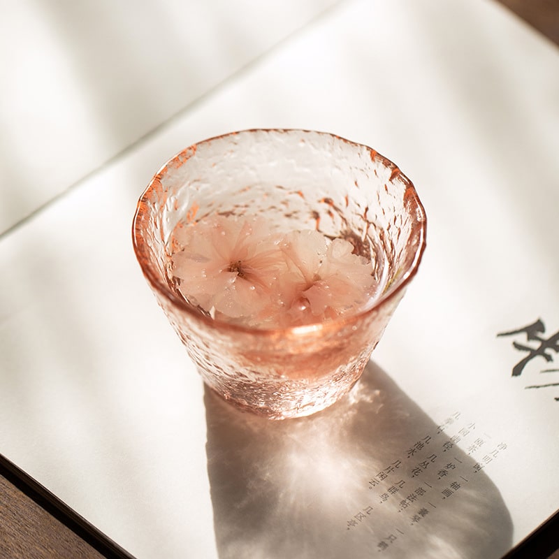 Cherry blossom-inspired pink glass cup with textured finish.