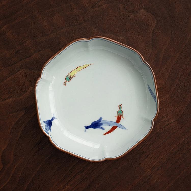 Hand-painted Japanese ceramic plates set displayed on a wooden table