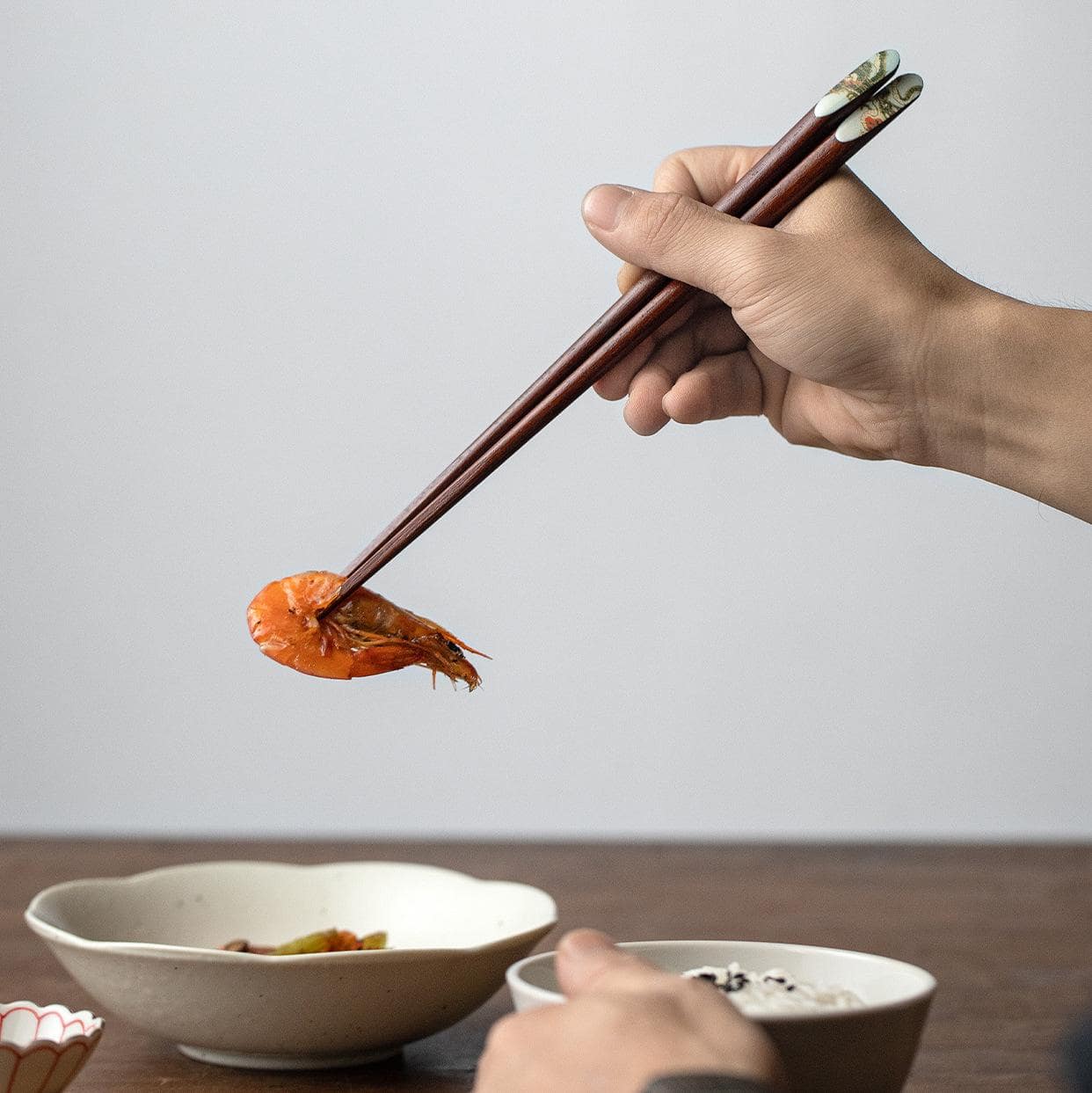 Set of dragon-themed wooden chopsticks on a white background