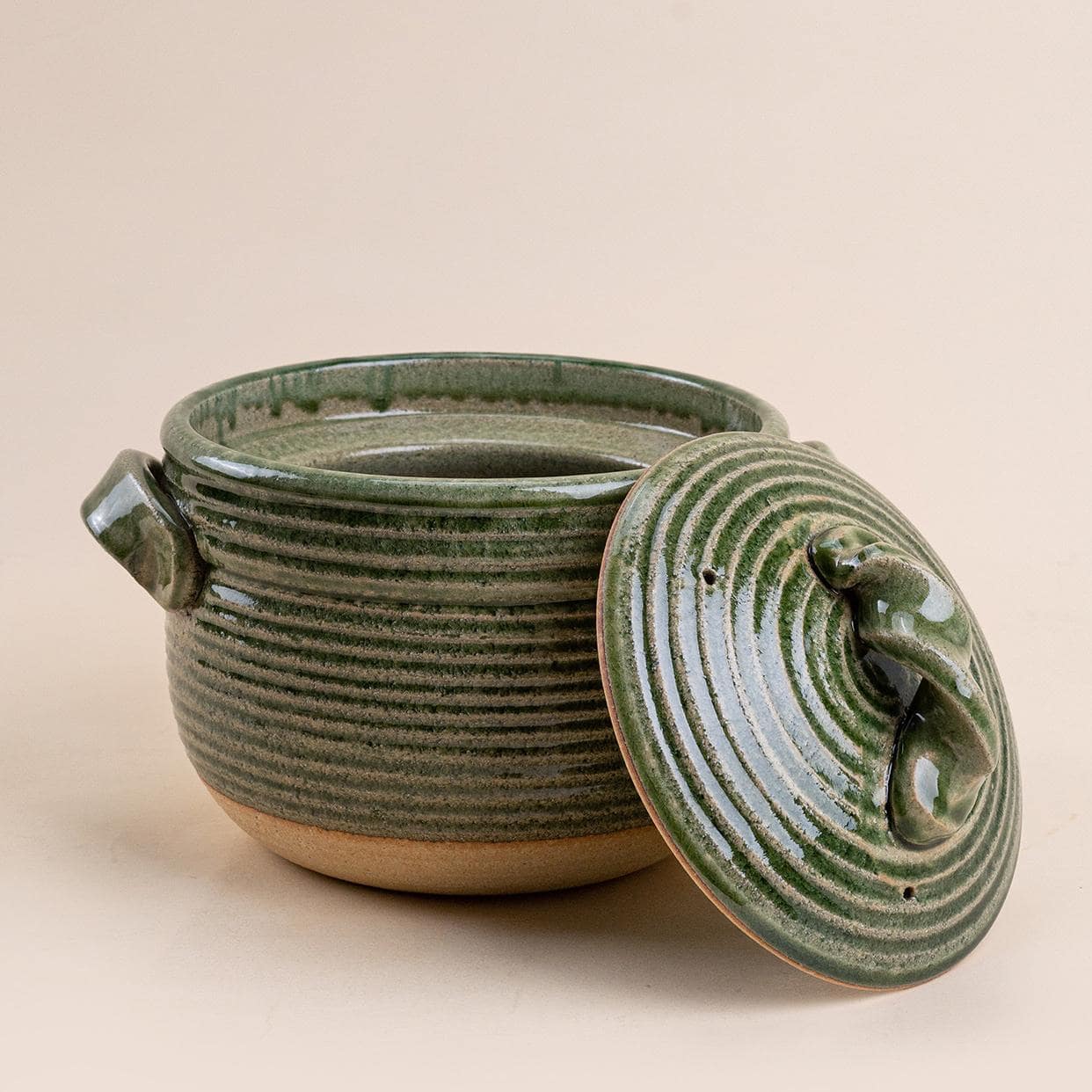 Brown Shinraku-yaki ceramic pot filled with hearty stew on a wooden table