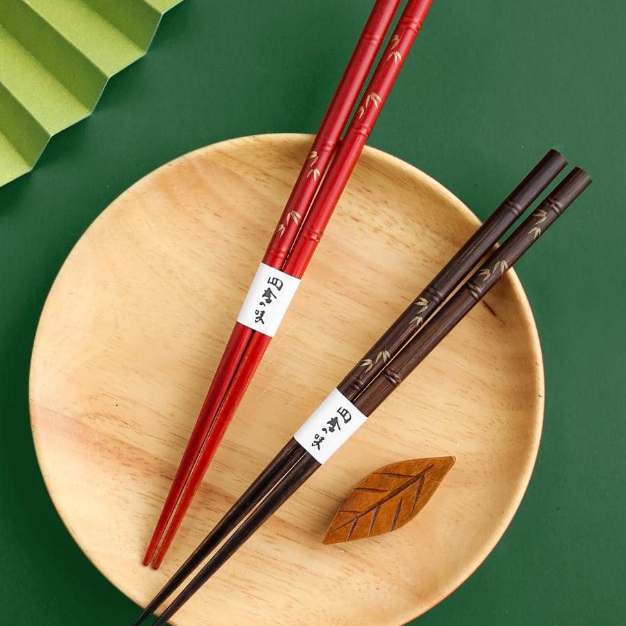 Premium wooden chopsticks showcasing fine engravings and lacquer finish.