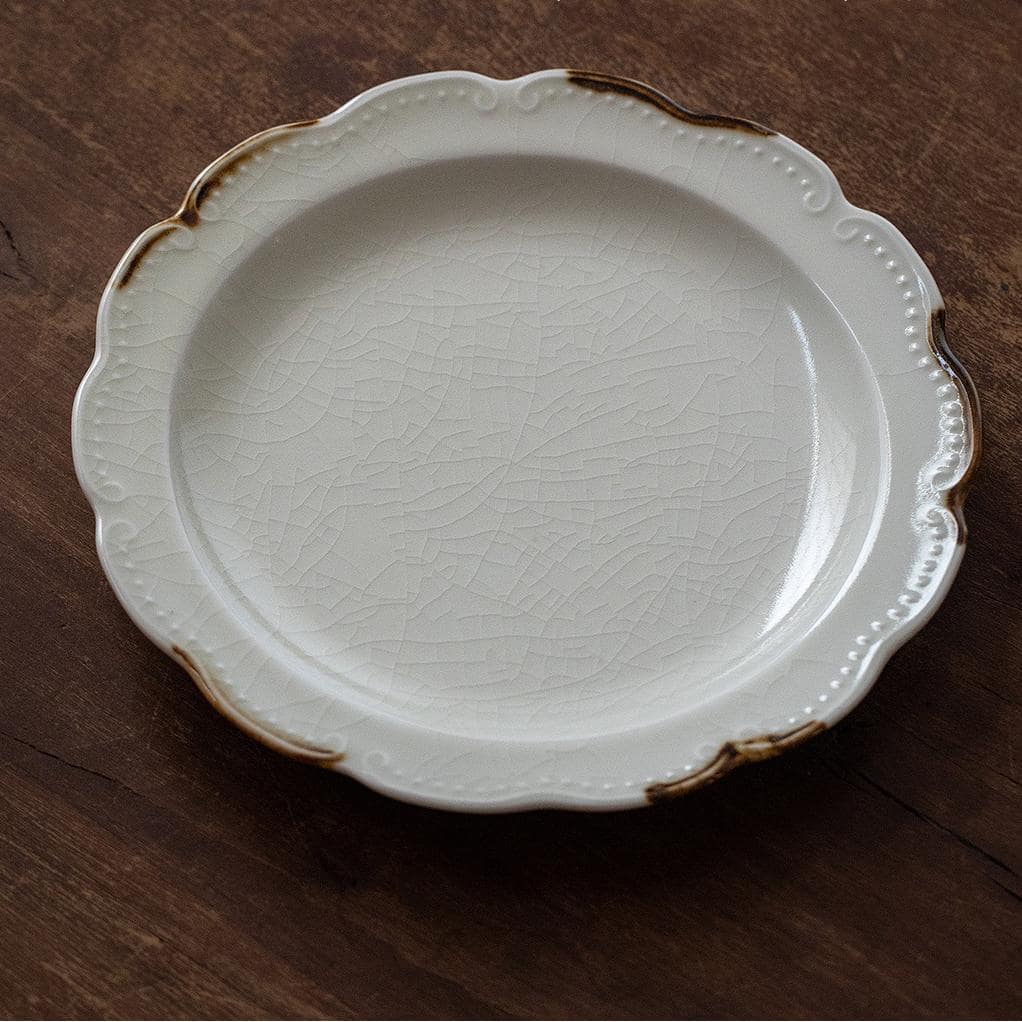 Artistic ceramic plate featuring elegant wavy edges.