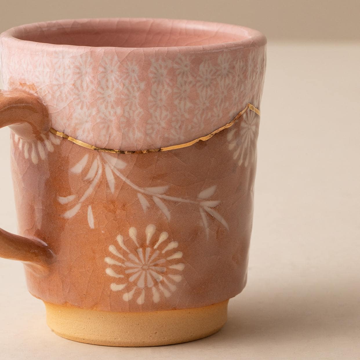 Close-up of a blue and brown ceramic mug with intricate detailing