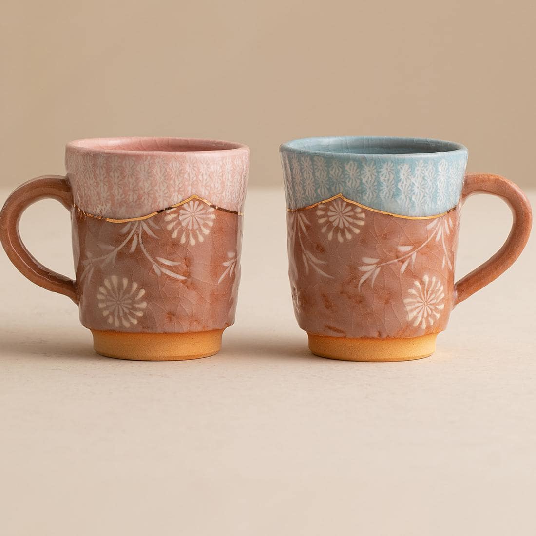 Artisanal ceramic mug collection featuring unique floral designs