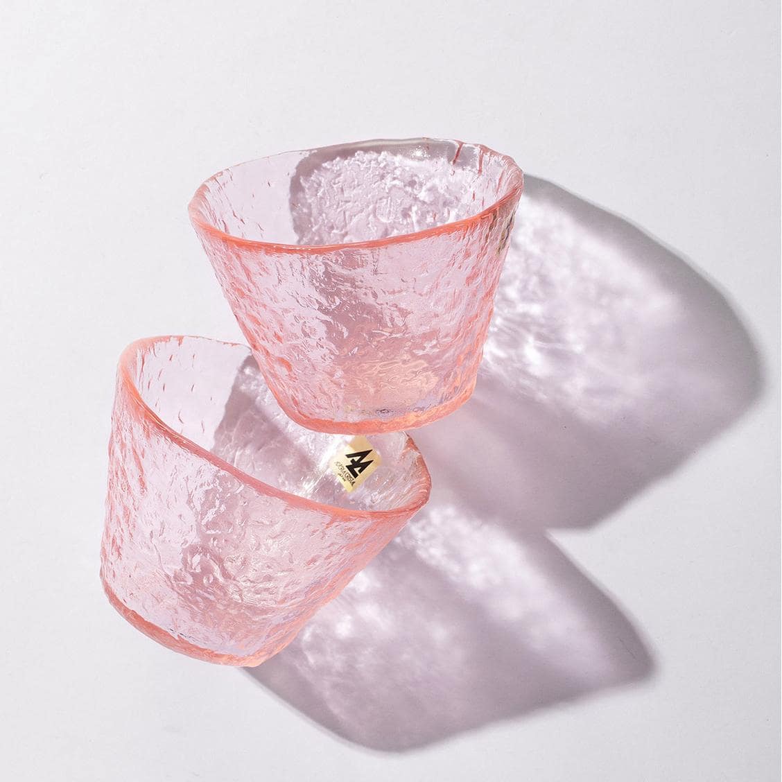 Textured pink glass cup for hot and cold drinks.