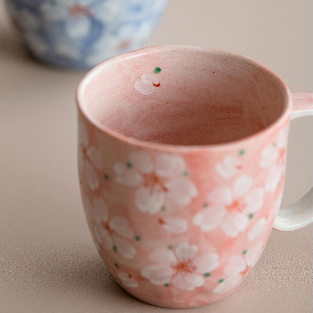 Close-up of the pink cherry blossom ceramic cup interior.