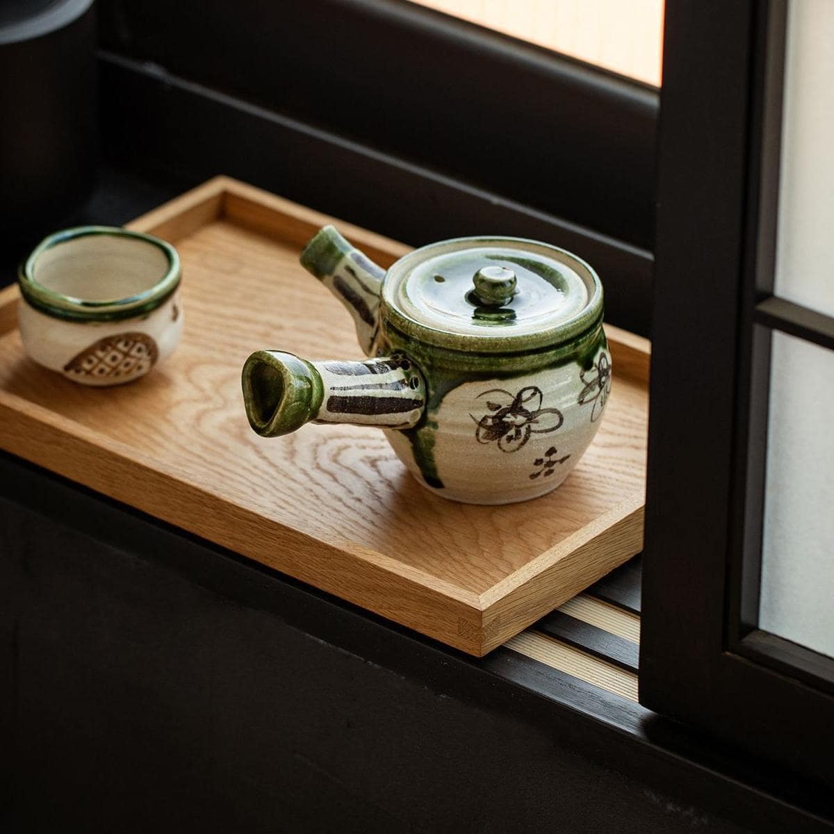 Side view of authentic Japanese Oribe Kyusu teapot with a green glaze.