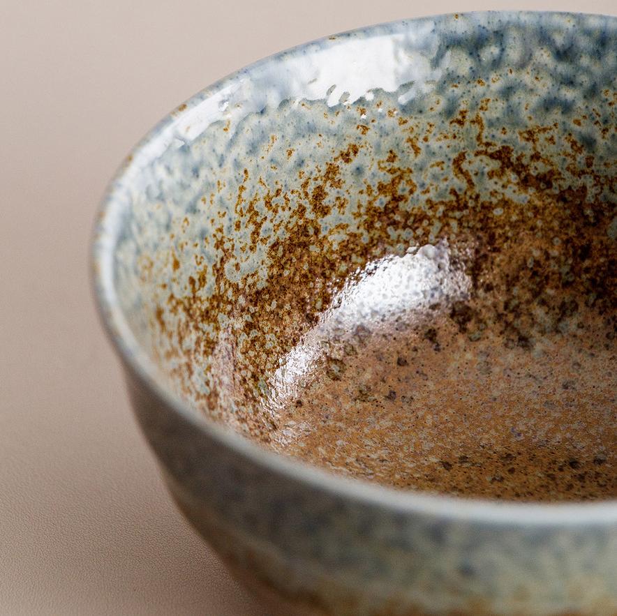 Stack of Japanese artisan ceramic bowls with unique glazes