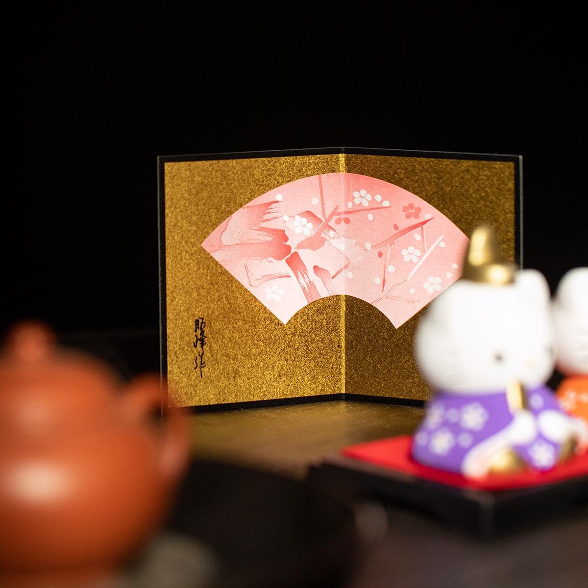 Decorative Hello Kitty couple ornaments on a wooden desk