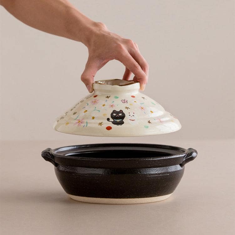 Two ceramic casserole pots showcasing unique Japanese artistry.