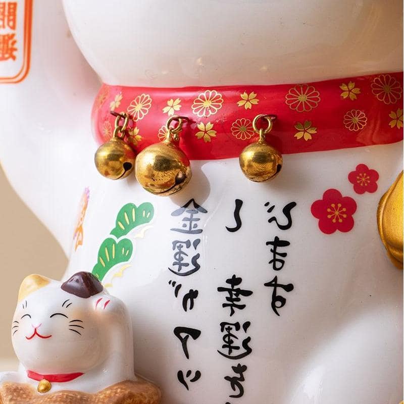 Japanese lucky cat ceramic decorations on a wooden table.