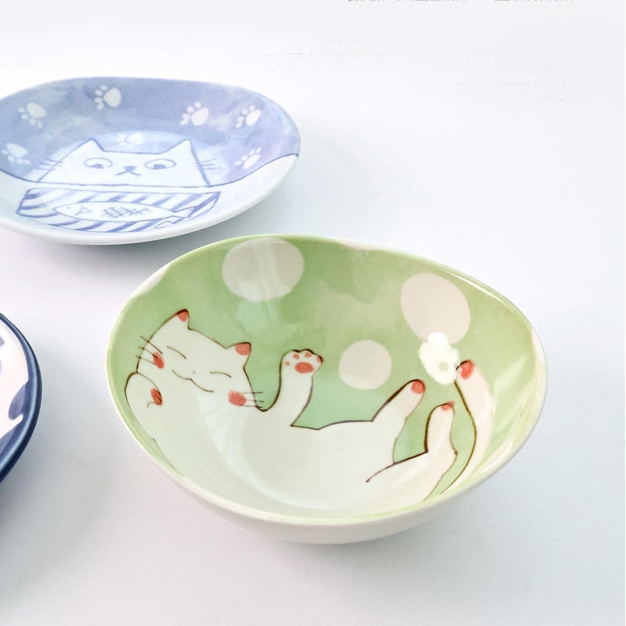 Handcrafted ceramic dipping bowl featuring a winking cat illustration