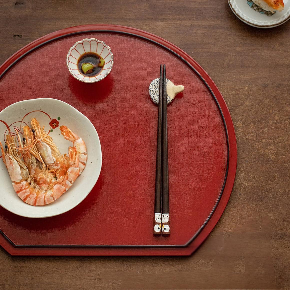 Natural wooden chopsticks with owl motif on a white plate