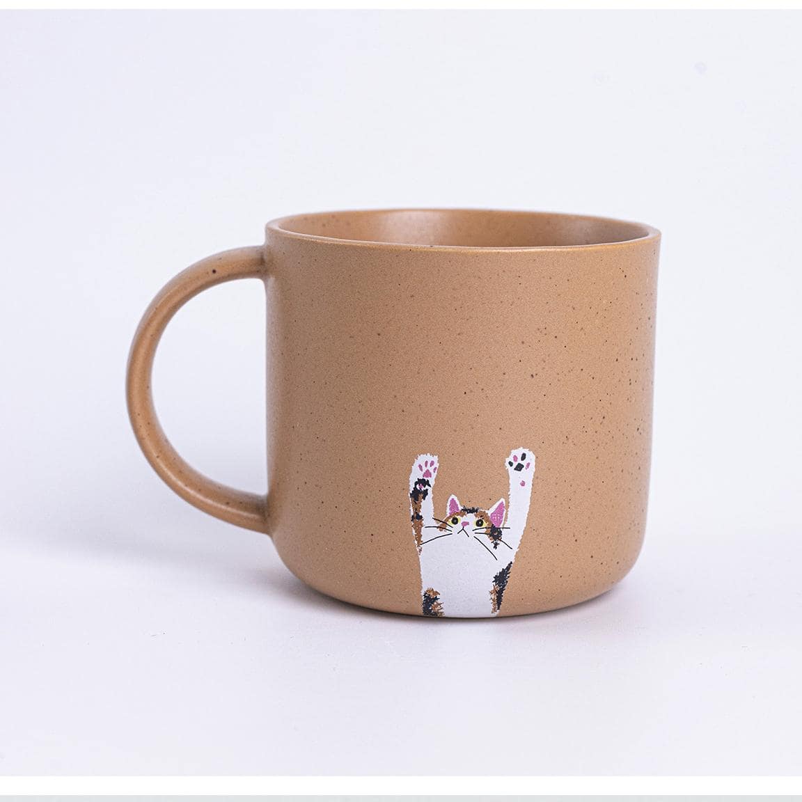 Bottom view of speckled ceramic mugs with paw-print design.