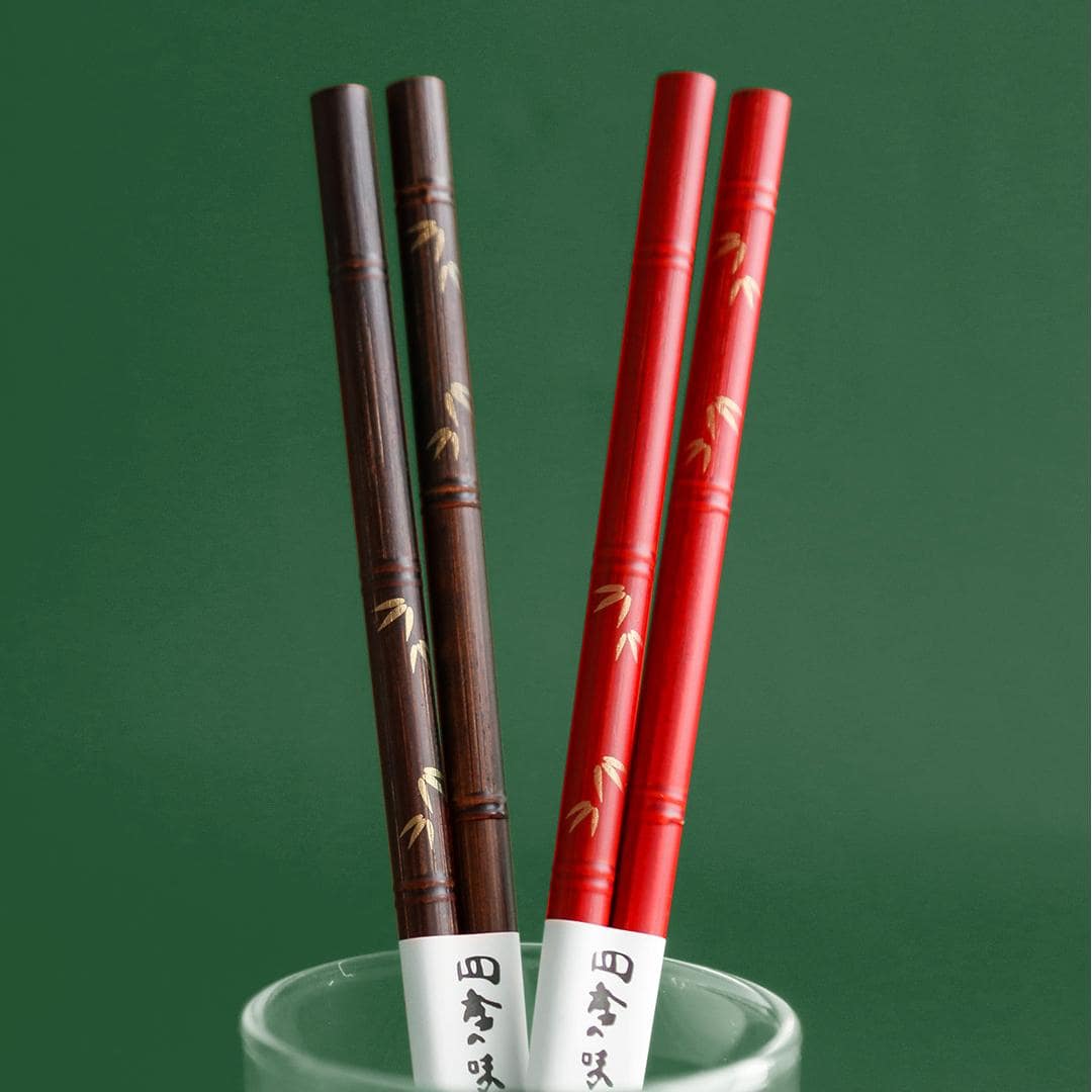 Premium wooden chopsticks showcasing fine engravings and lacquer finish.